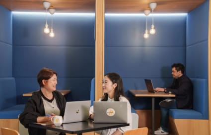 Cozy coworking booths with modern lighting, perfect for collaboration and focus.