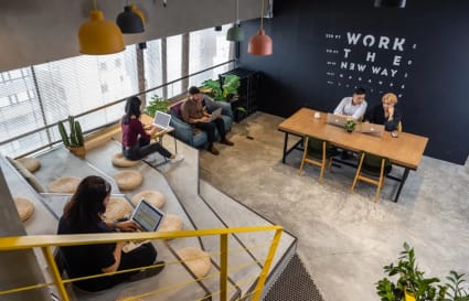 Modern coworking space with open seating, natural light, and creative design. Perfect for collaboration.