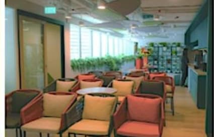 Bright coworking space with comfortable seating and greenery, ideal for collaboration.