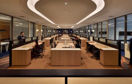 Modern coworking space with sleek desks, ambient lighting, and collaborative areas.
