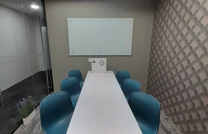 Efficient meeting room with modern seating, whiteboard, and stylish decor in Orchard Road coworking space.