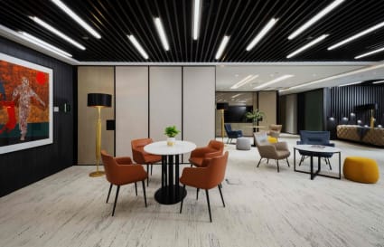 Sleek coworking space with modern furniture and vibrant seating. Ideal for collaboration and creativity.