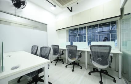 Modern coworking space with ergonomic chairs, clean desks, and ample natural light.