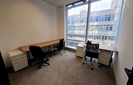 Bright, flexible coworking space with large windows and modern furnishings on How Ming Street.
