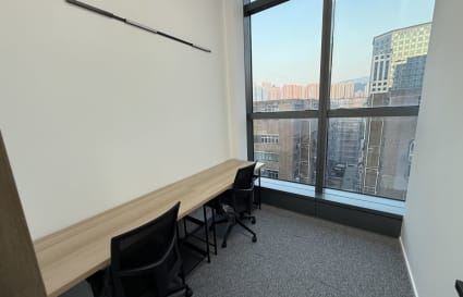 Bright coworking space with large windows and modern desk setup on Wang Chiu Road, Kowloon.