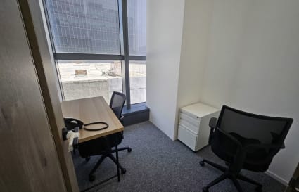 Bright, minimalist office with modern desks and ergonomic chairs in Kowloon coworking space.