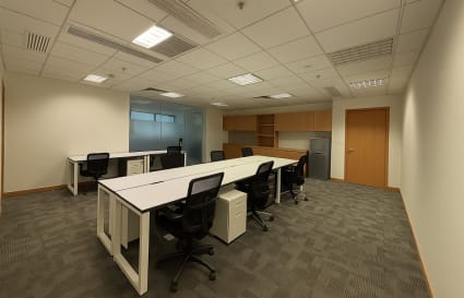 Modern coworking space with shared desks, ample storage, and natural lighting in Kwun Tong Road.