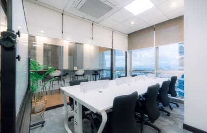 Bright coworking space with large windows, modern desks, and ergonomic chairs in Pasig.