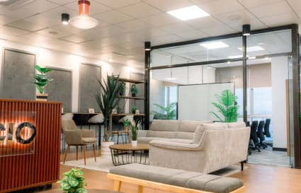 Modern coworking space with comfy seating, natural light, and greenery in Pasig.