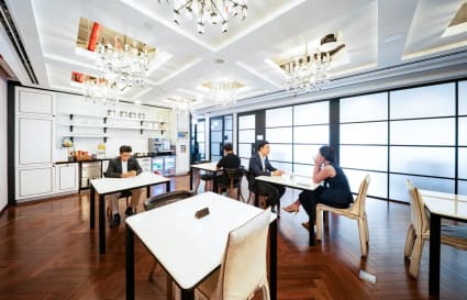 Elegant coworking space with natural light, sleek tables, and modern amenities in Ho Chi Minh City.