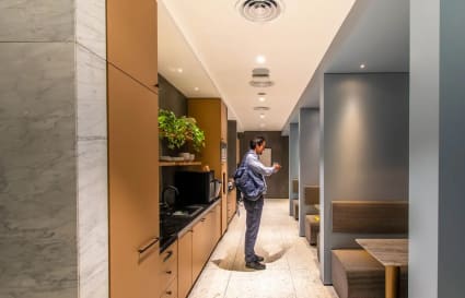 Sleek kitchenette and cozy seating areas, perfect for breaks and informal meetings.