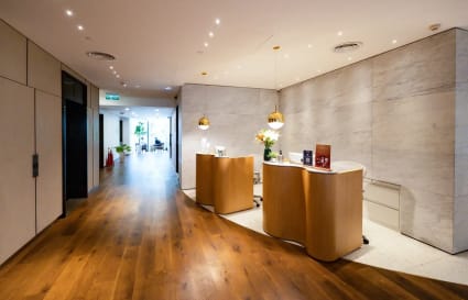 Welcoming reception area with sleek wood floors and modern lighting.