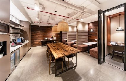 Stylish coworking space with modern amenities, wooden accents, and cozy seating areas in Ho Chi Minh City.