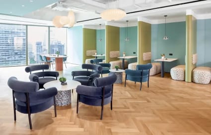 Stylish coworking area with modern seating, natural light, and city views. Ideal for collaboration.