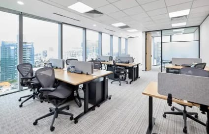 Bright coworking space with city views, ergonomic chairs, and modern desks. Ideal for productivity.