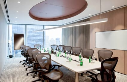 Sleek conference room with modern seating and city views, ideal for dynamic meetings.