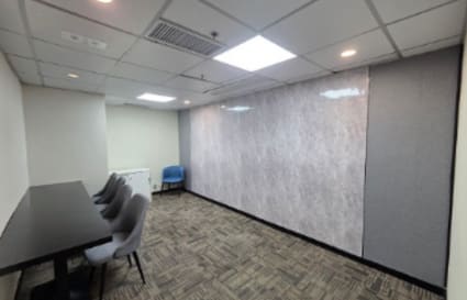 Modern coworking space with bright lighting, versatile seating, and a sleek design on Mody Road.