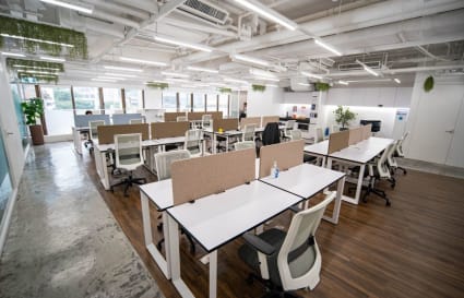 Modern coworking space with open layout, natural light, and ergonomic workstations in Admiralty.