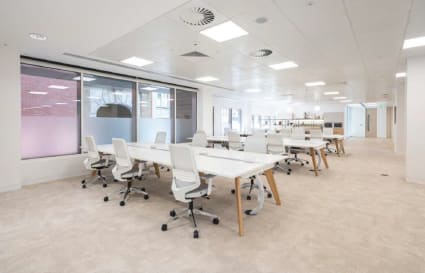 Bright, open coworking space with modern furnishings on Victoria Street, Singapore.