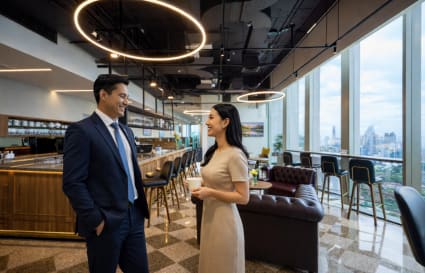 Modern coworking space with open lounge, bar seating, and skyline views in Bang Rak. Perfect for networking.
