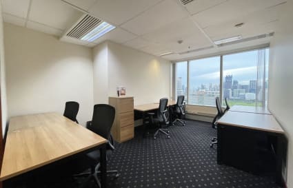 Bright coworking space with city views, ergonomic chairs, and ample desk space in Pathumwan.