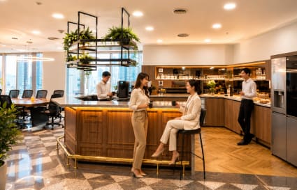 Modern coworking space with a stylish kitchen, ample seating, and vibrant atmosphere.
