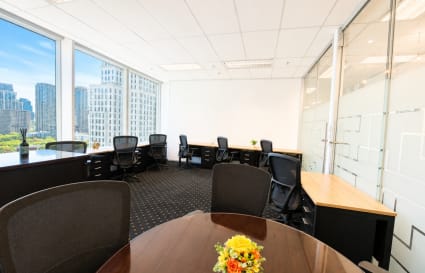 Bright coworking space with city views, modern desks, and sleek decor in Pathumwan.
