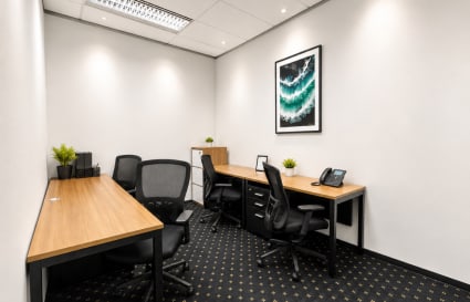 Modern coworking space with sleek desks, ergonomic chairs, and natural decor in Pathumwan.