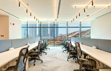 Bright coworking space with ergonomic chairs, modern design, and city views in Za’abeel 1.
