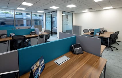 Modern coworking space with modular desks, ergonomic chairs, and natural light. Ideal for productivity.