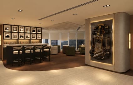 Stylish coworking lounge with bar seating and art display, perfect for networking and relaxation.