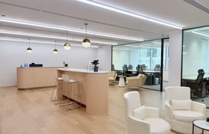 Elegant coworking space with modern seating, natural light, and sleek wood finishes in Taikoo Shing.