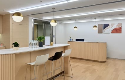 Modern coworking space with sleek counters, stylish lighting, and a welcoming atmosphere.