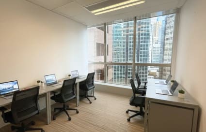 Bright coworking space with city views, modern desks, and ergonomic chairs in Tsim Sha Tsui.