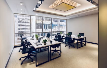 Bright coworking space with modern desks, ergonomic chairs, and natural light in Tsim Sha Tsui.