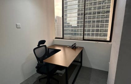 Compact office with city views, ergonomic chair, and ample natural light. Ideal for private work.