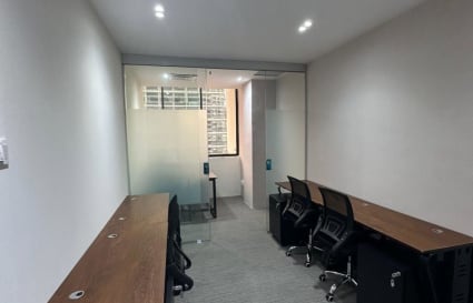 Sleek coworking space with natural light, comfy chairs, and modern wooden desks on Anson Road.