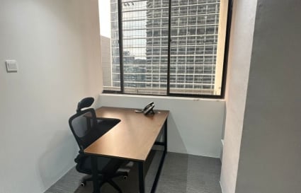 Compact office with natural light and city view, perfect for focused work.