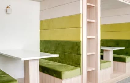 Stylish coworking booths with modern design and vibrant seating in Hiap Hoe Building.