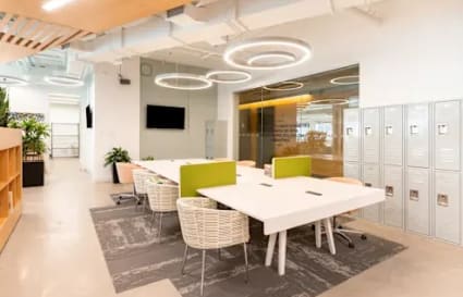 Modern coworking space with stylish seating, lockers, and vibrant lighting in Hiap Hoe Building.
