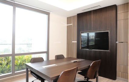 Bright meeting room with modern table, ergonomic chairs, and natural light. Perfect for collaboration.