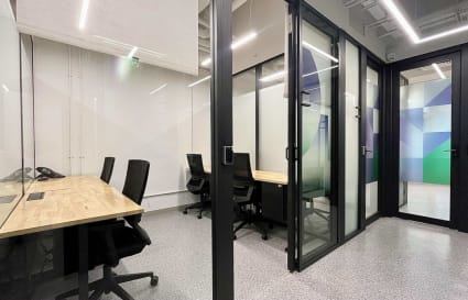 Modern coworking space with private offices, sleek furnishings, and ample natural light in Sheung Wan.