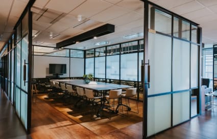 Elegant, open meeting room with ample seating, modern decor, and natural light. Perfect for collaboration.