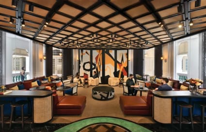 Stylish coworking space with modern decor, ample seating, and abundant natural light in Singapore.