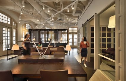 Stylish coworking space in Singapore featuring modern design, warm lighting, and flexible seating.