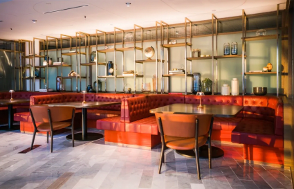 Stylish coworking lounge with plush seating and sleek shelving in central Singapore.