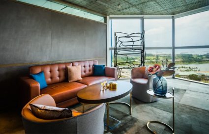 Stylish coworking lounge with plush seating and stunning city views. Ideal for networking.