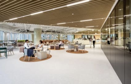 Modern coworking space with open layout, cozy seating, and abundant natural light. Ideal for collaboration.