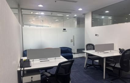 Modern coworking space with sleek desks, comfortable chairs, and natural lighting. Ideal for productivity.