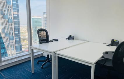 Bright workspace with city views, ergonomic chairs, and modern desks in Marasi Drive, Dubai.